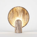 Travertine Table Lamp, switched on against a plain studio background