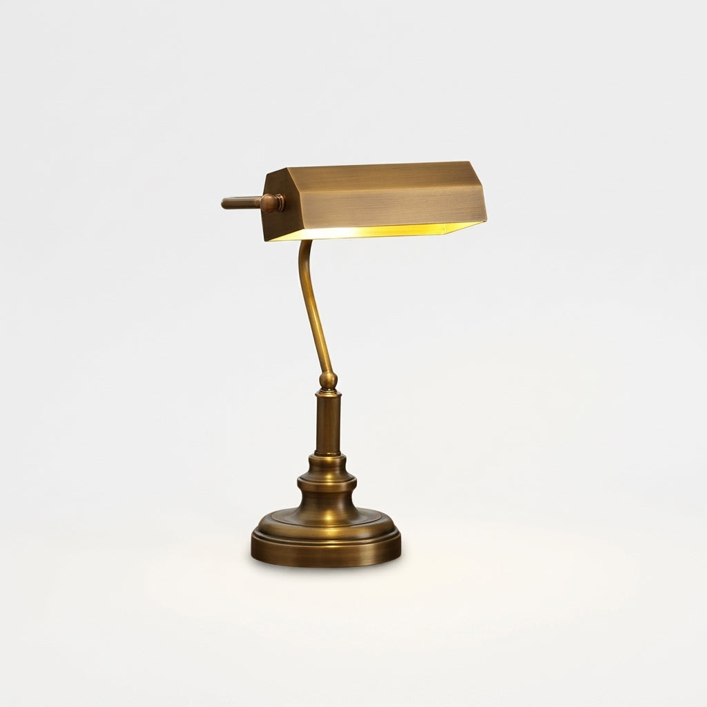 Antiqued Brass Library Desk Lamp, switched on against a plain studio background