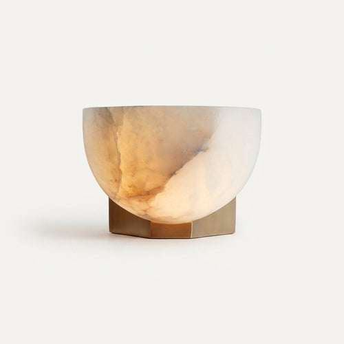 Brass and Alabaster Disc Sconce, switched on against a plain studio background
