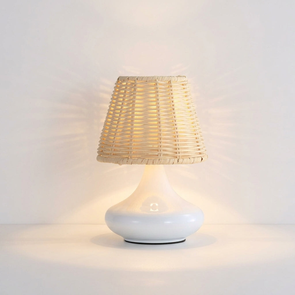 Woven Bamboo Table Lamp, switched on against a plain studio background
