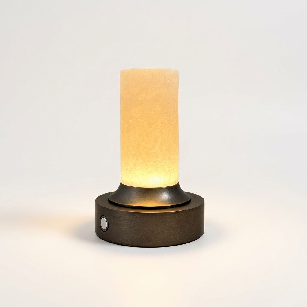 Bronze and Alabaster Cordless Lamp, switched on against a plain studio background