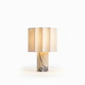 Marble and Fabric Cordless Table Lamp, switched on against a plain studio background