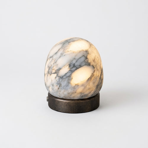 Alabaster Dome Cordless Lamp, switched on against a plain studio background