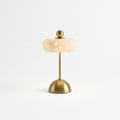 Alabaster Disc Table Lamp, switched on against a plain studio background