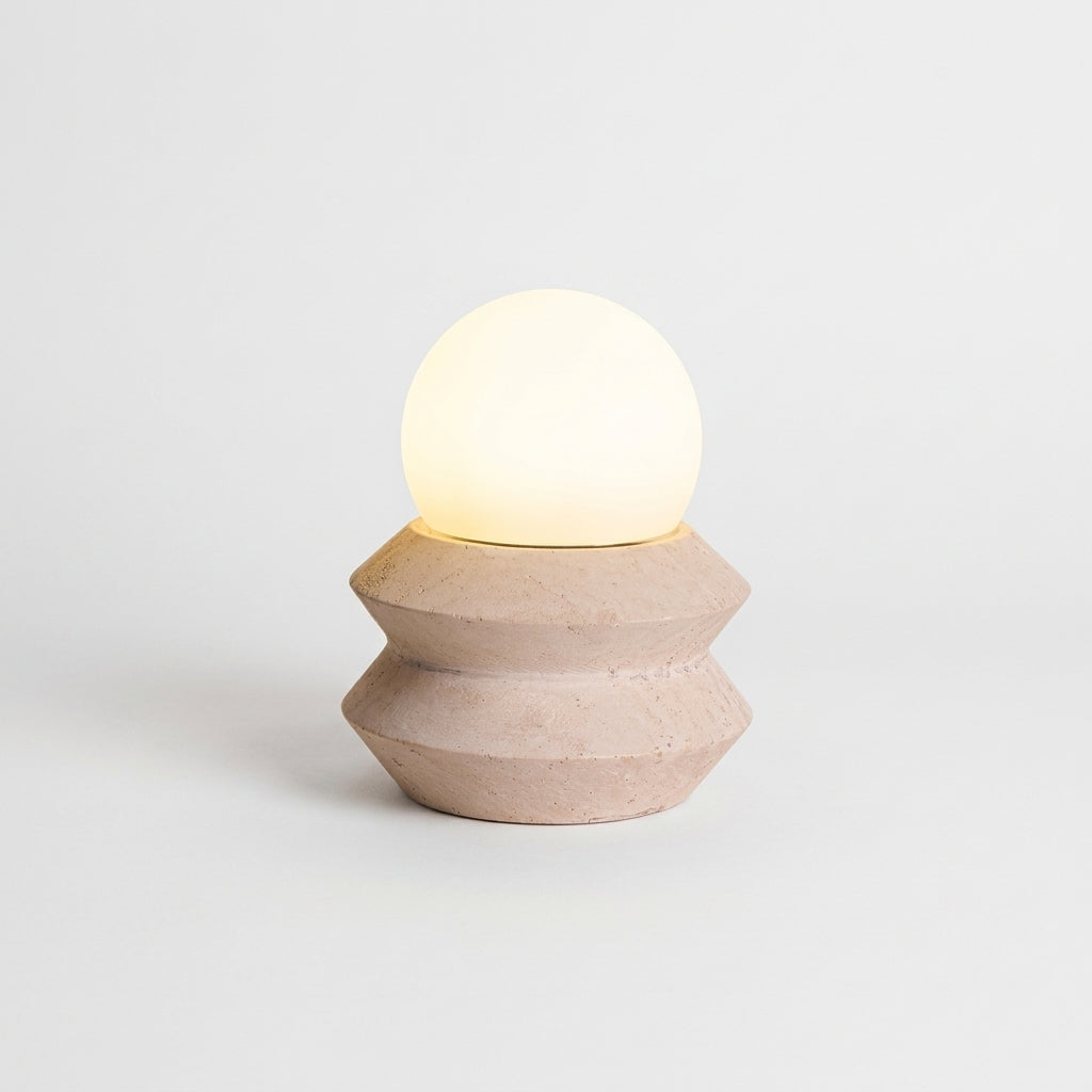 Travertine Cube Cordless Lamp, switched on against a plain studio background