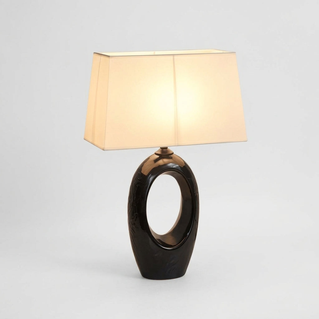 Ceramic and Fabric Table Lamp, switched on against a plain studio background