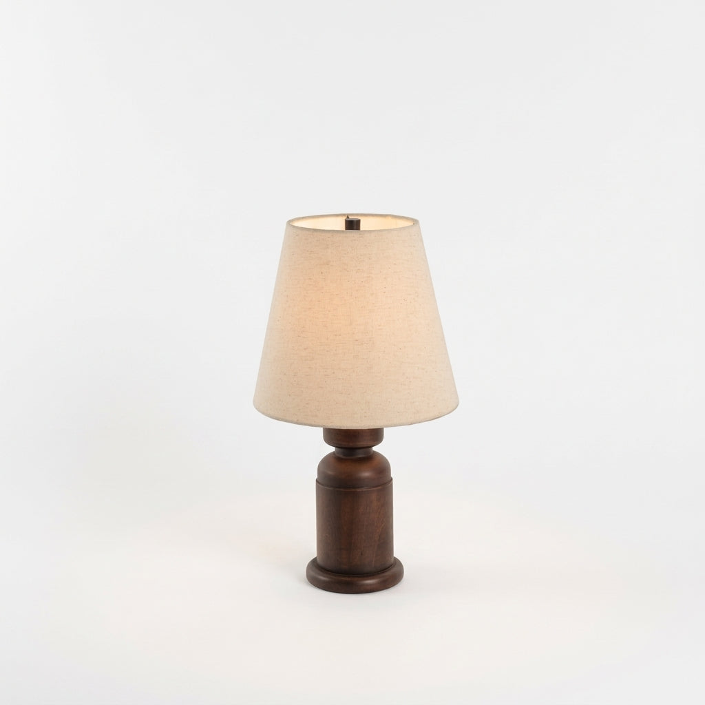 Walnut Wood Table Lamp, switched on against a plain studio background