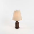 Walnut Wood Table Lamp, switched on against a plain studio background