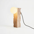 Travertine Column Table Lamp, switched on against a plain studio background