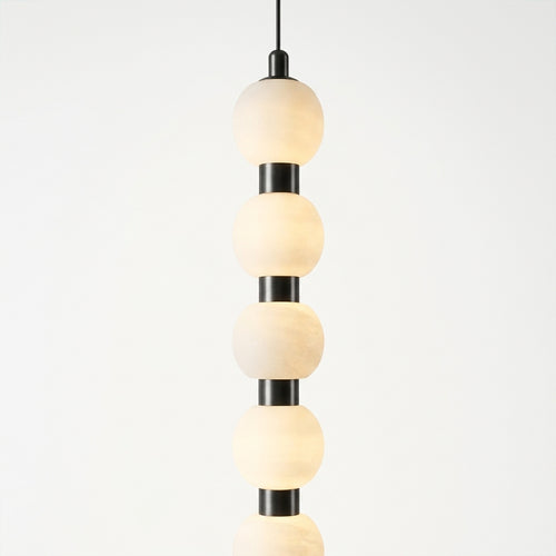 Close detail of the alabaster shades, metal on the Alabaster Strand Pendant