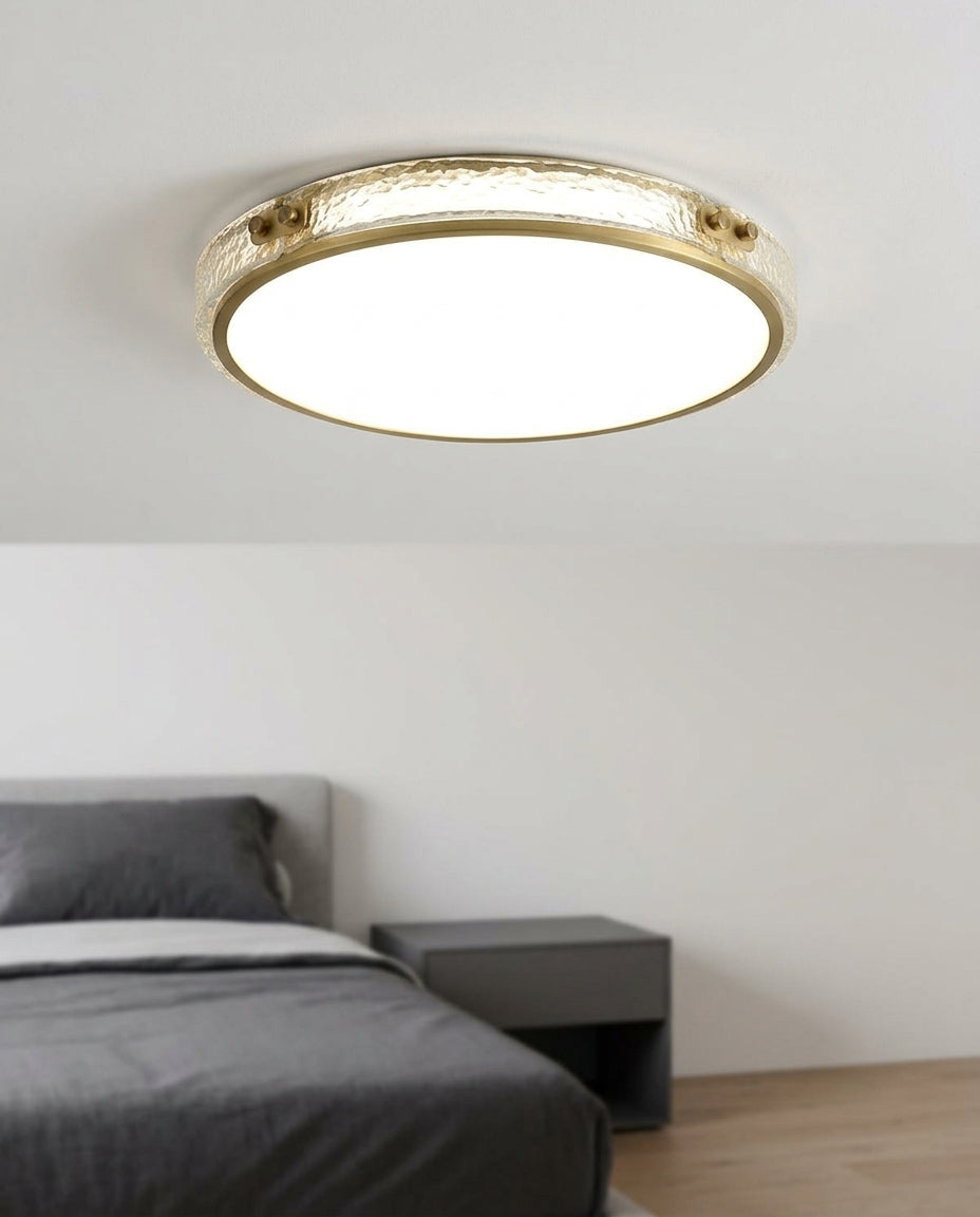 Brass and Crystal Ceiling Light mounted on the ceiling of a calm modern bedroom, seen from below at a slight angle