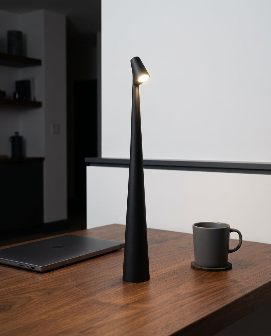 Slim Aluminum Stick Lamp standing on a walnut desk beside a laptop and a ceramic mug, evening, the rest of the room dim
