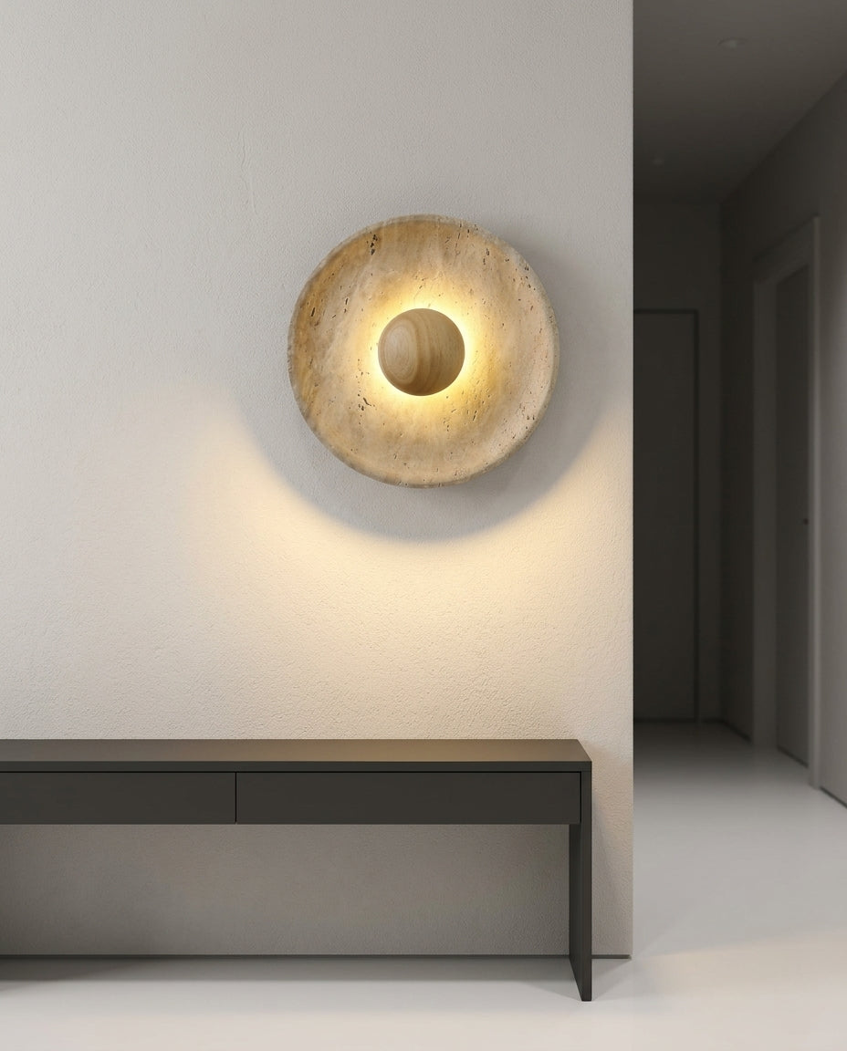 Travertine and Wood Wall Light mounted on an off-white hallway wall above a low console, evening, warm pool of light on the wall