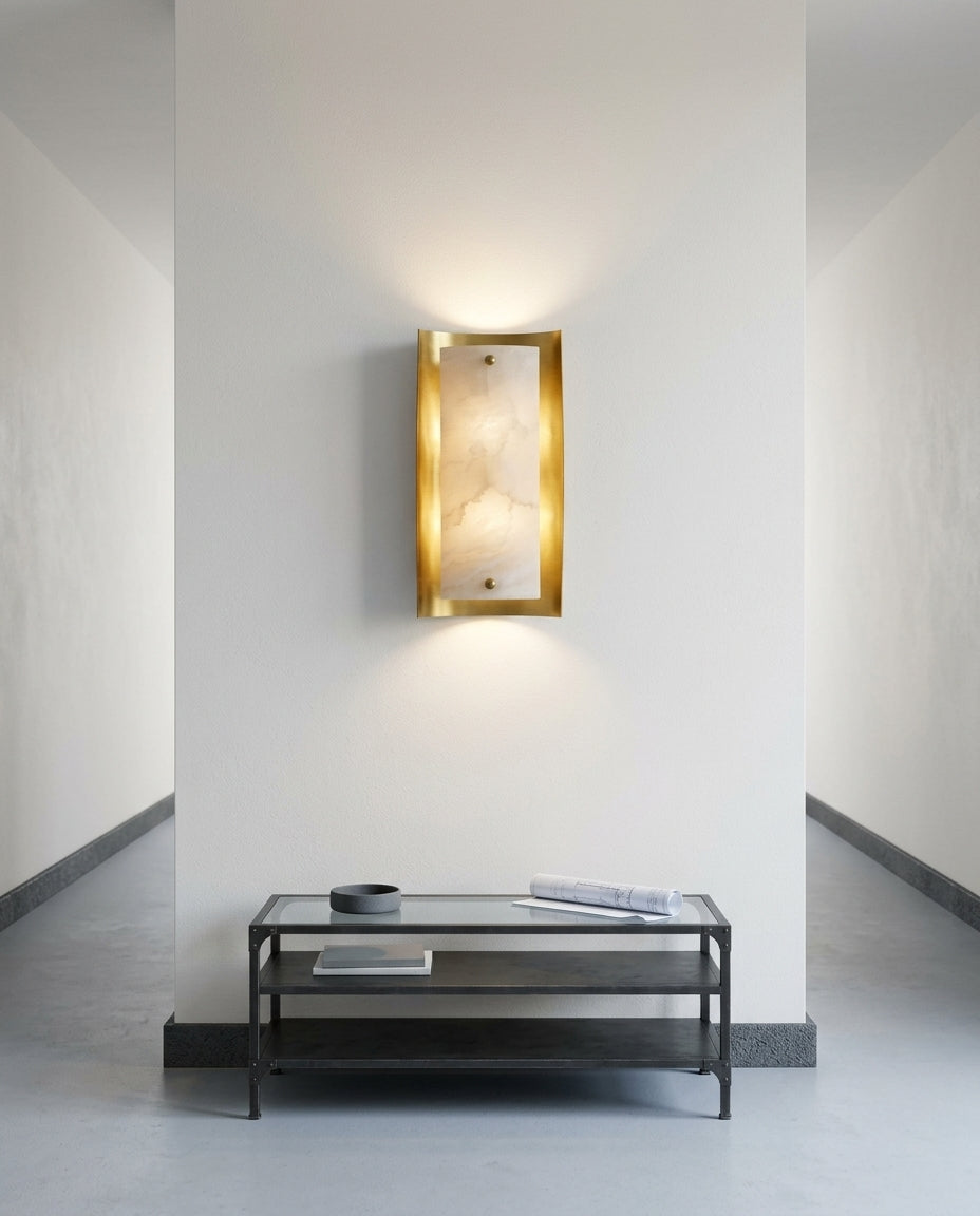 Tall Alabaster and Brass Wall Lamp mounted on an off-white hallway wall above a low console, evening, warm pool of light on the wall