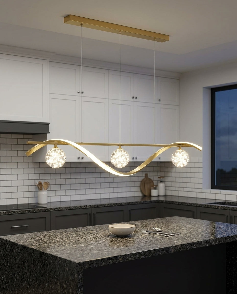 Globe and Metal Pendant hanging above a kitchen island with a stone worktop, modern American kitchen, evening