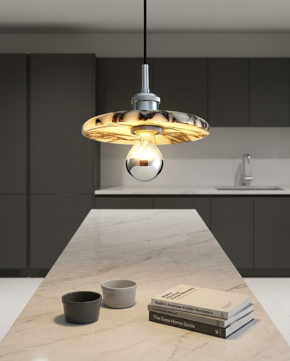 Marble Cylinder Pendant Light hanging above a kitchen island with a stone worktop, modern American kitchen, evening