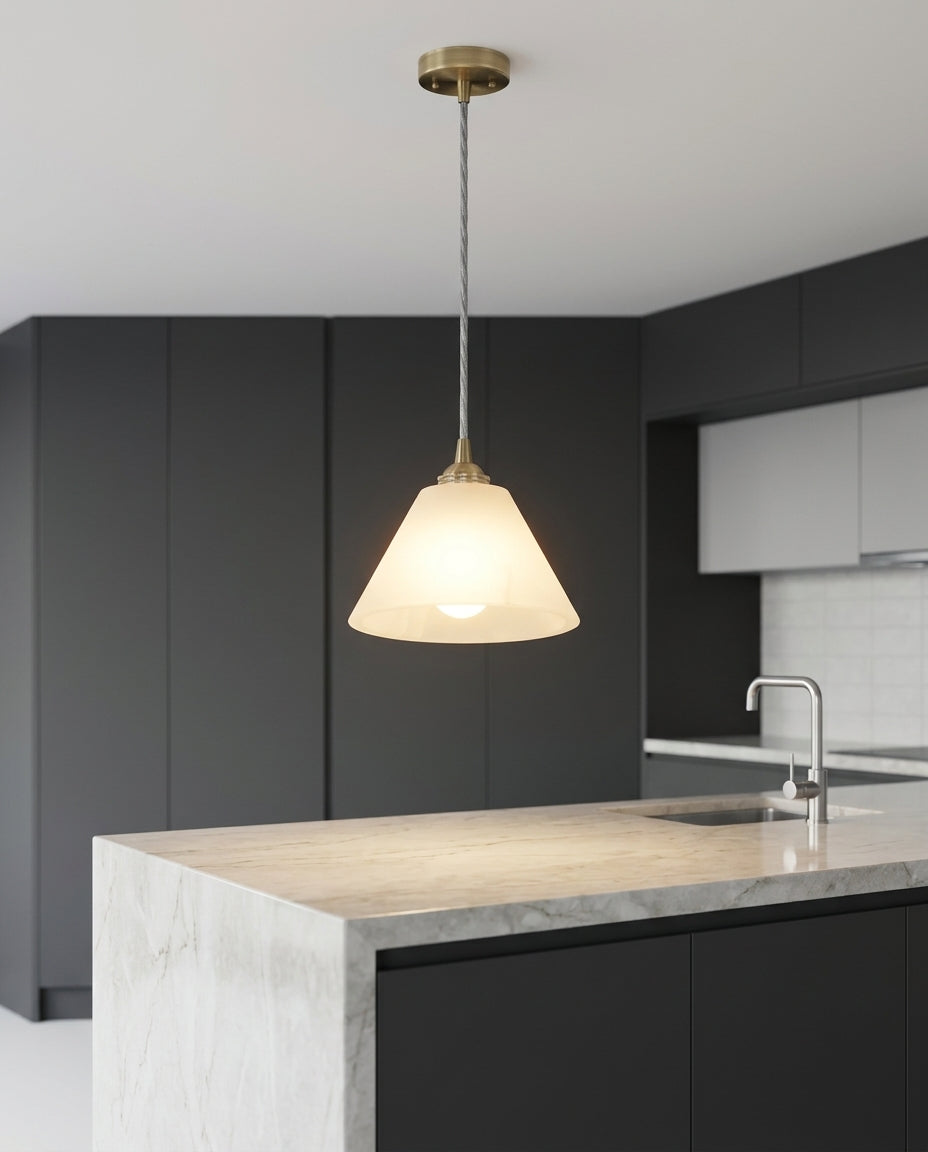 Small Alabaster Pendant Light hanging above a kitchen island with a stone worktop, modern American kitchen, evening
