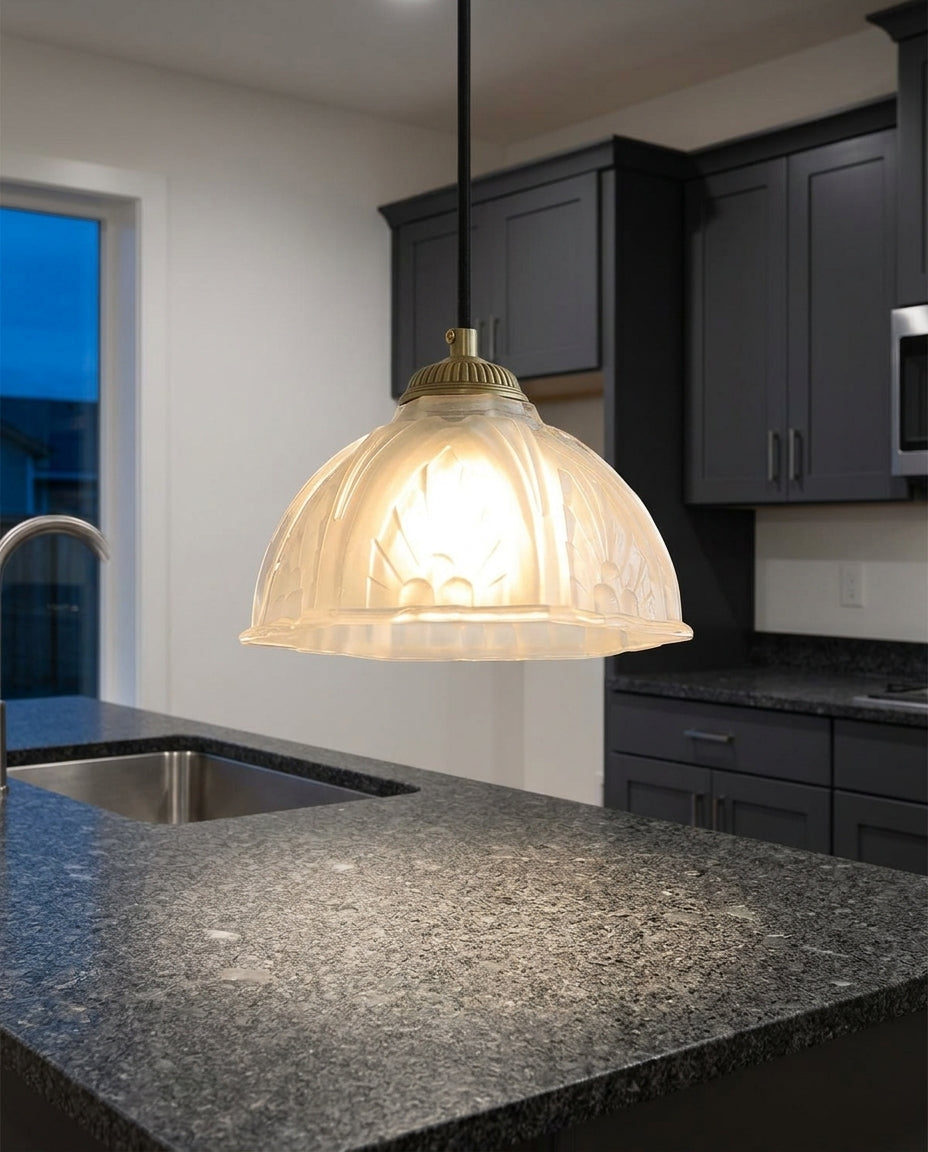 Scalloped Glass Petal Pendant Light hanging above a kitchen island with a stone worktop, modern American kitchen, evening