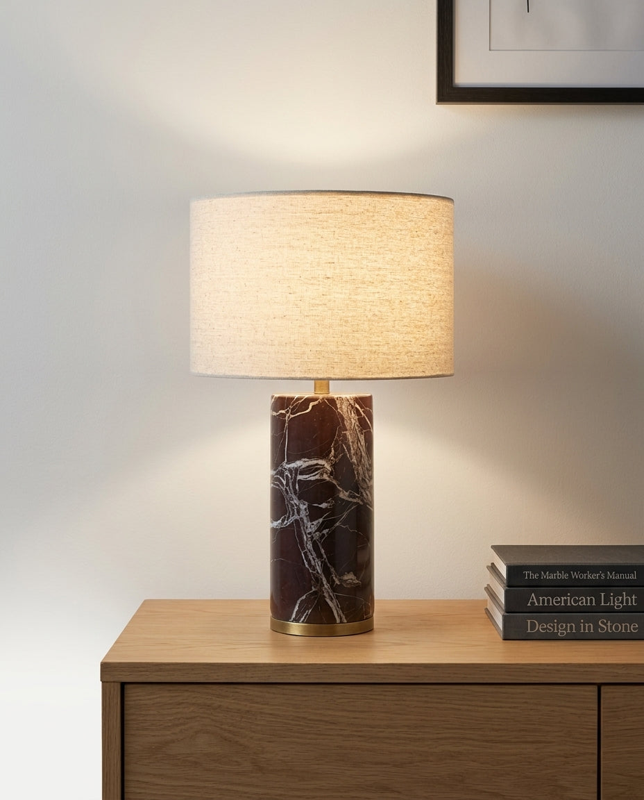 Veined Marble Table Lamp on an oak sideboard against an off-white wall, evening, a small stack of books beside it