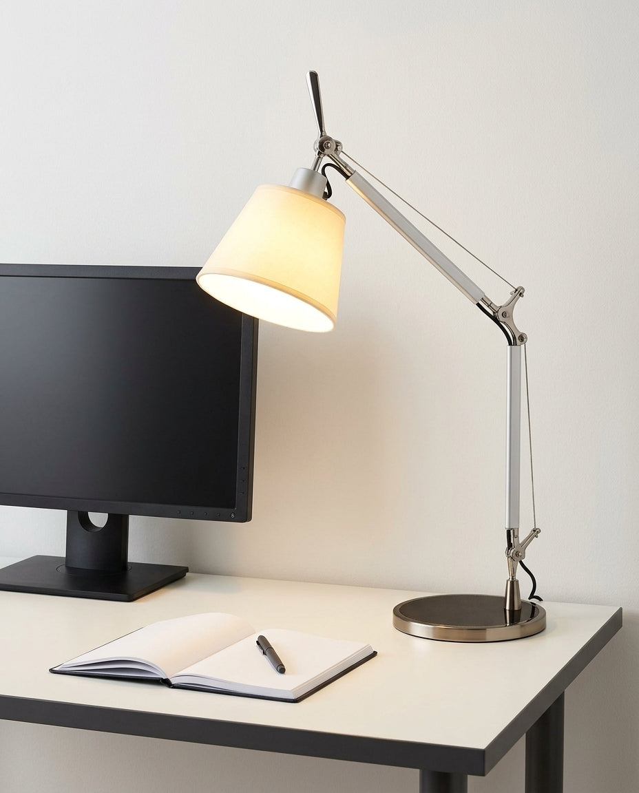 Cantilever Parchment Task Lamp on a tidy home-office desk with a monitor and a notebook, task light pooled on the desk surface