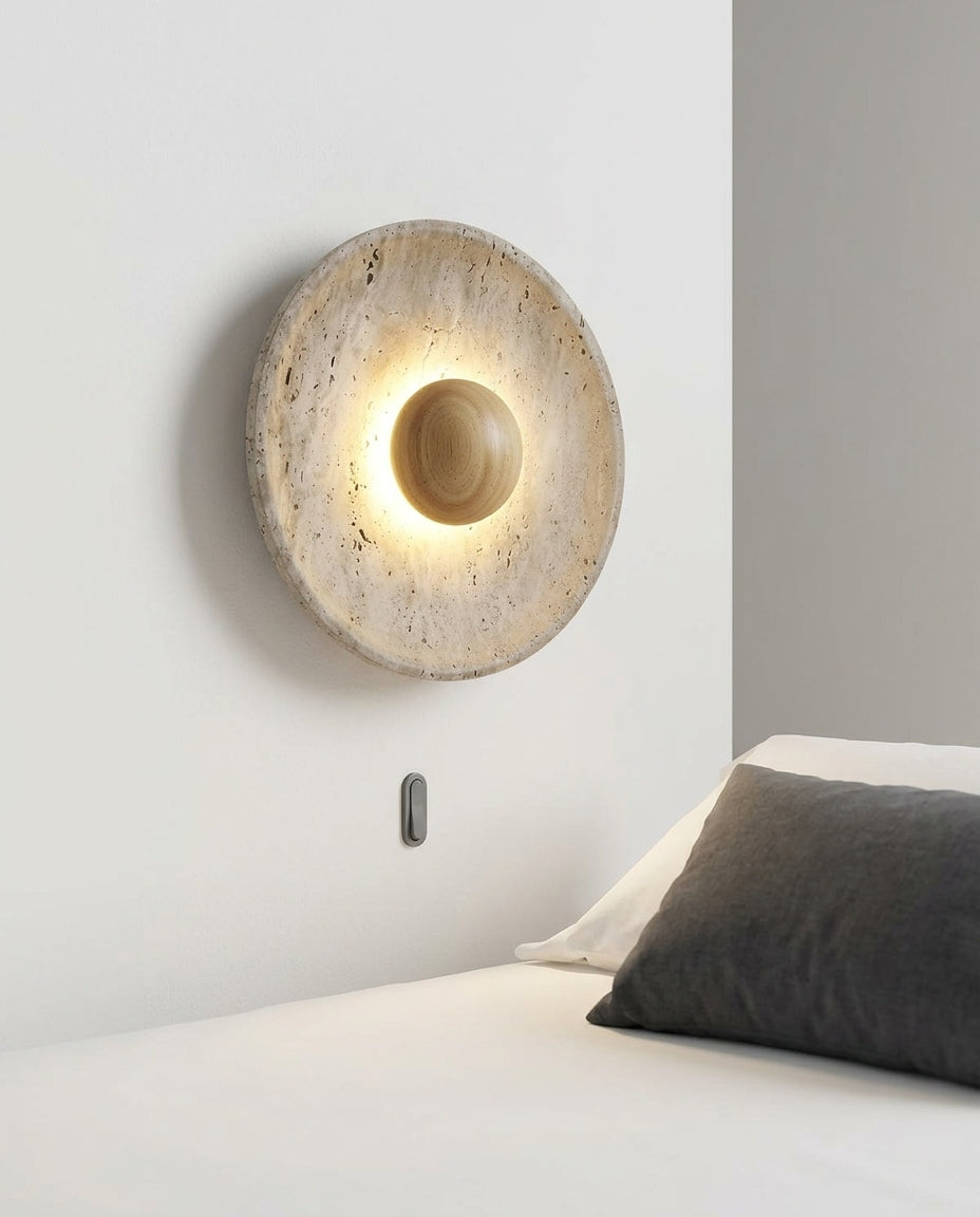 Travertine and Wood Wall Light mounted on the wall beside a bed in place of a bedside lamp, reading light angled down