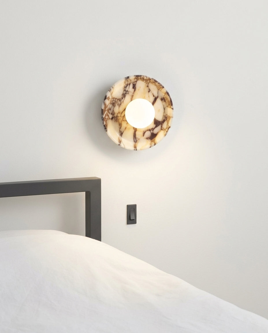 Purple Marble and Frosted Glass Wall Light mounted on the wall beside a bed in place of a bedside lamp, reading light angled down