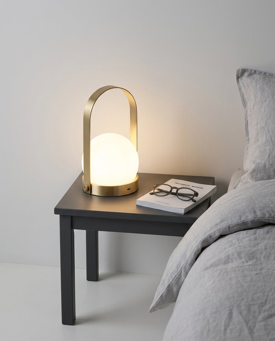 Dome Glass Cordless Lamp on a bedside table beside a folded throw, warm evening light