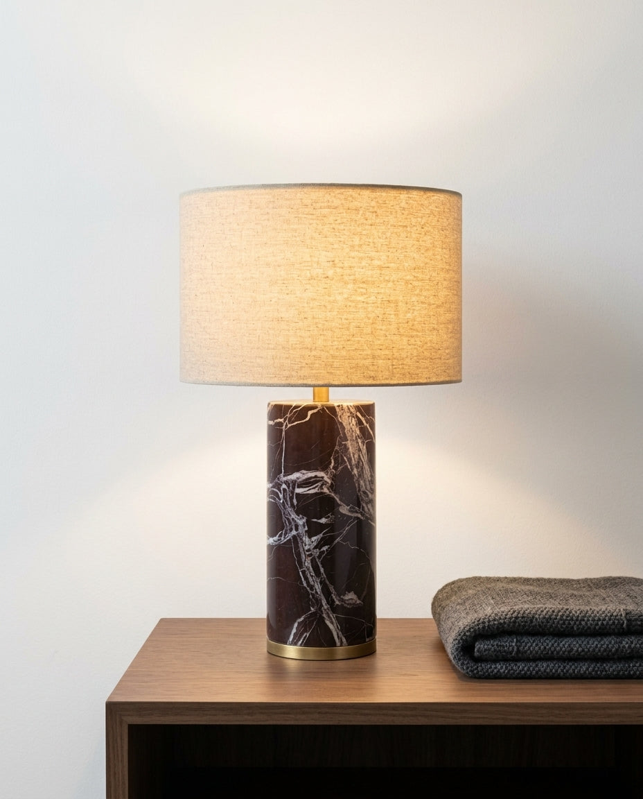 Veined Marble Table Lamp on a bedside table beside a folded throw, warm evening light