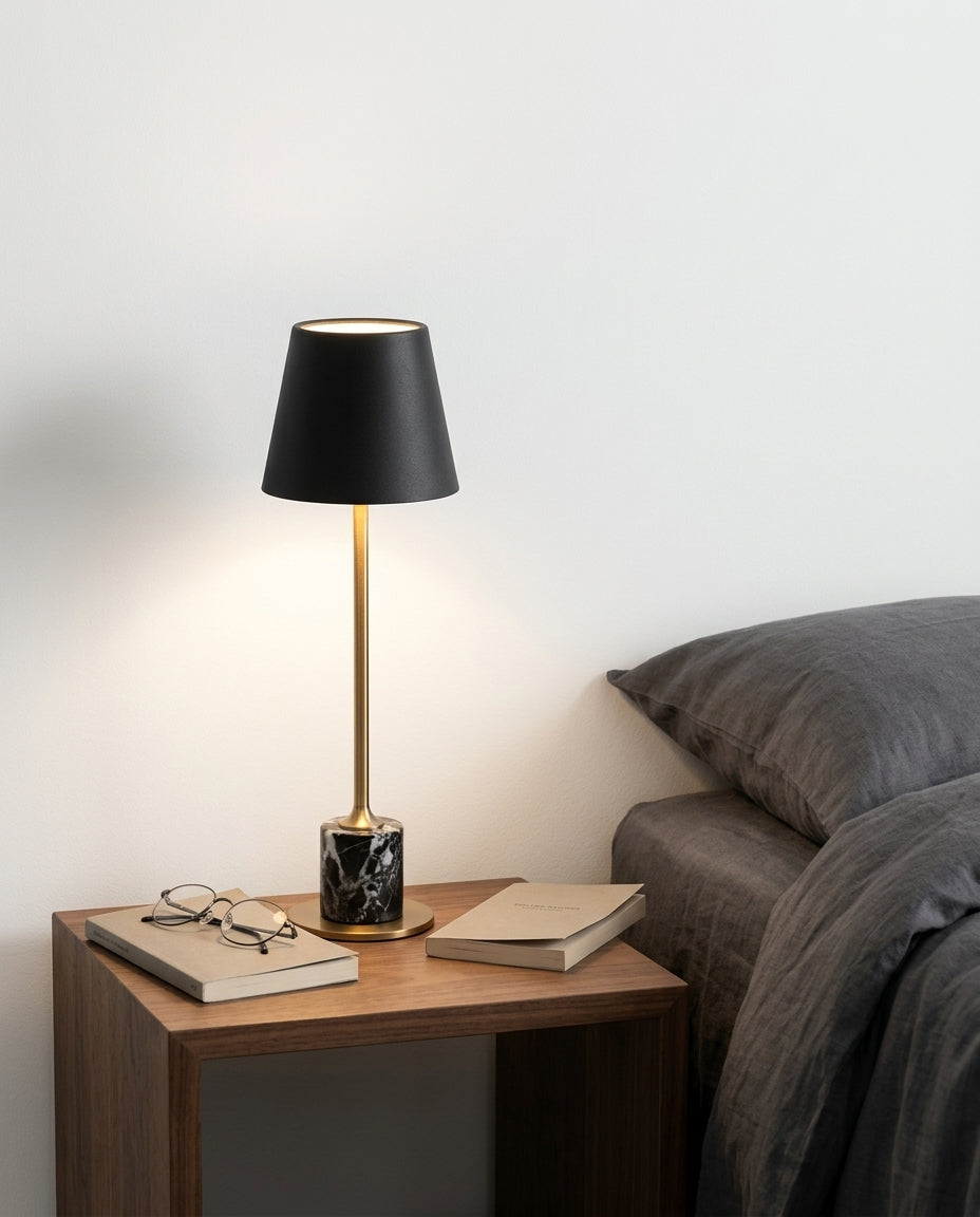 Mini Marble Stem Lamp on a bedside table beside a folded throw, warm evening light