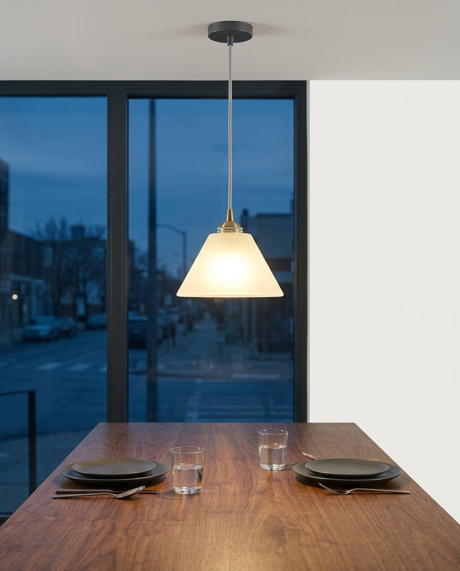 Small Alabaster Pendant Light hanging above a walnut dining table set for two, blue-hour light through a large window