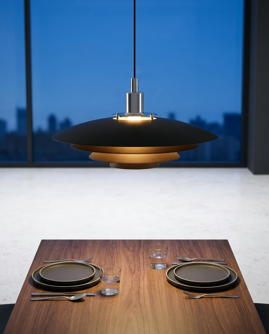 Tiered Metal Dome Pendant Light hanging above a walnut dining table set for two, blue-hour light through a large window