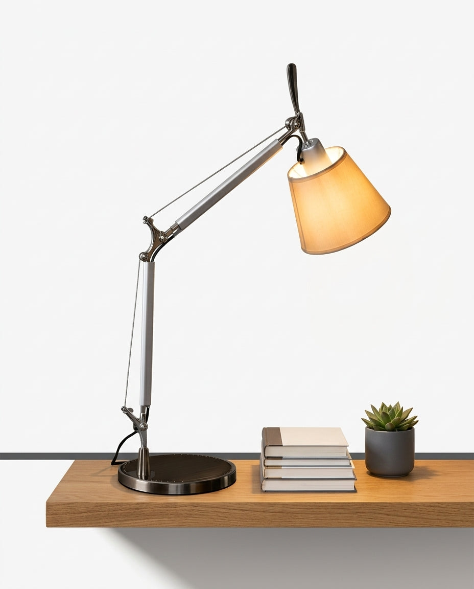 Cantilever Parchment Task Lamp on an oak shelf beside a few hardback books and a small plant, evening