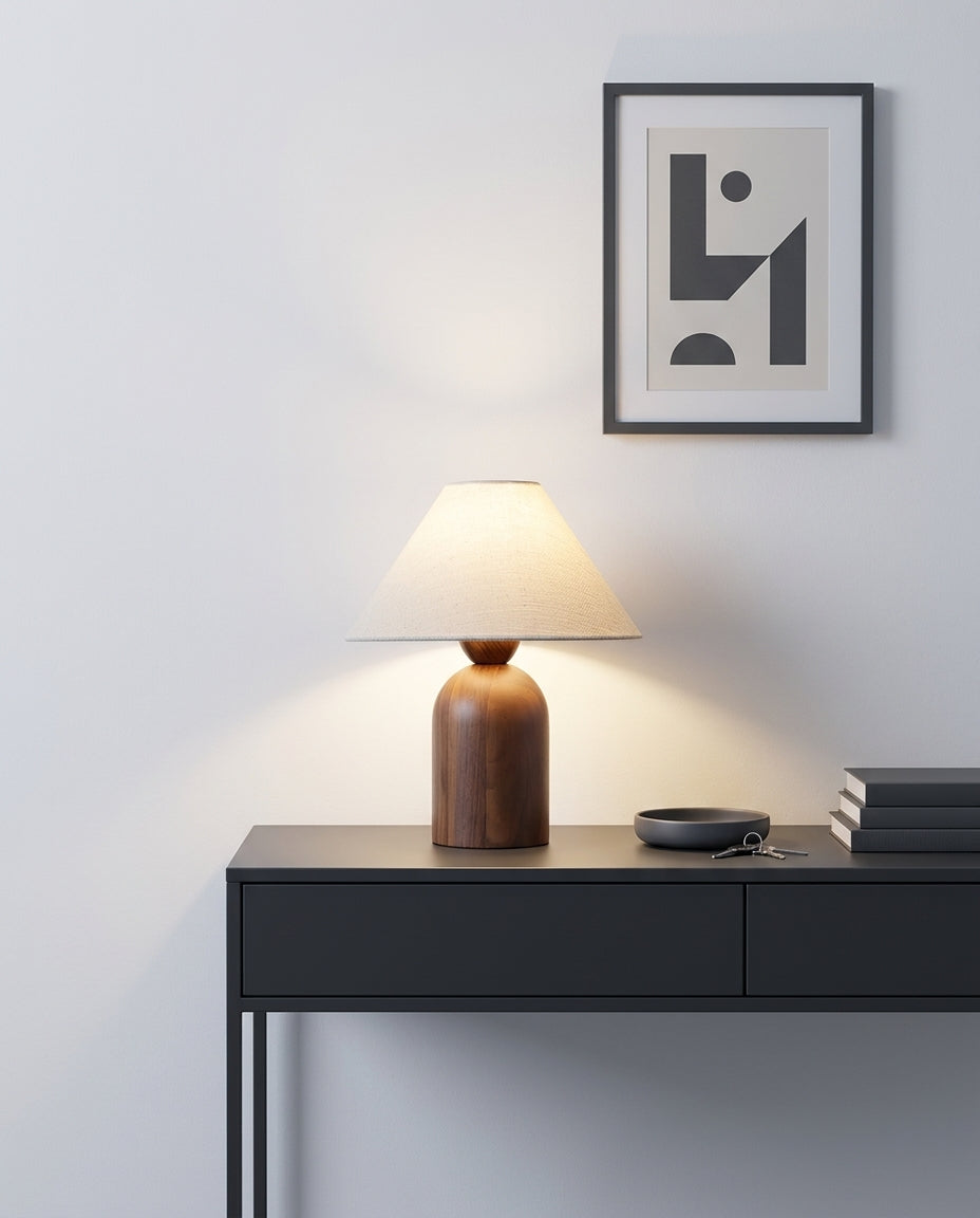 Linen and Walnut Table Lamp on an entryway console table below a framed print, evening