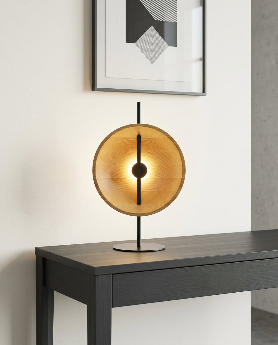 Wood Disc Table Lamp on an entryway console table below a framed print, evening