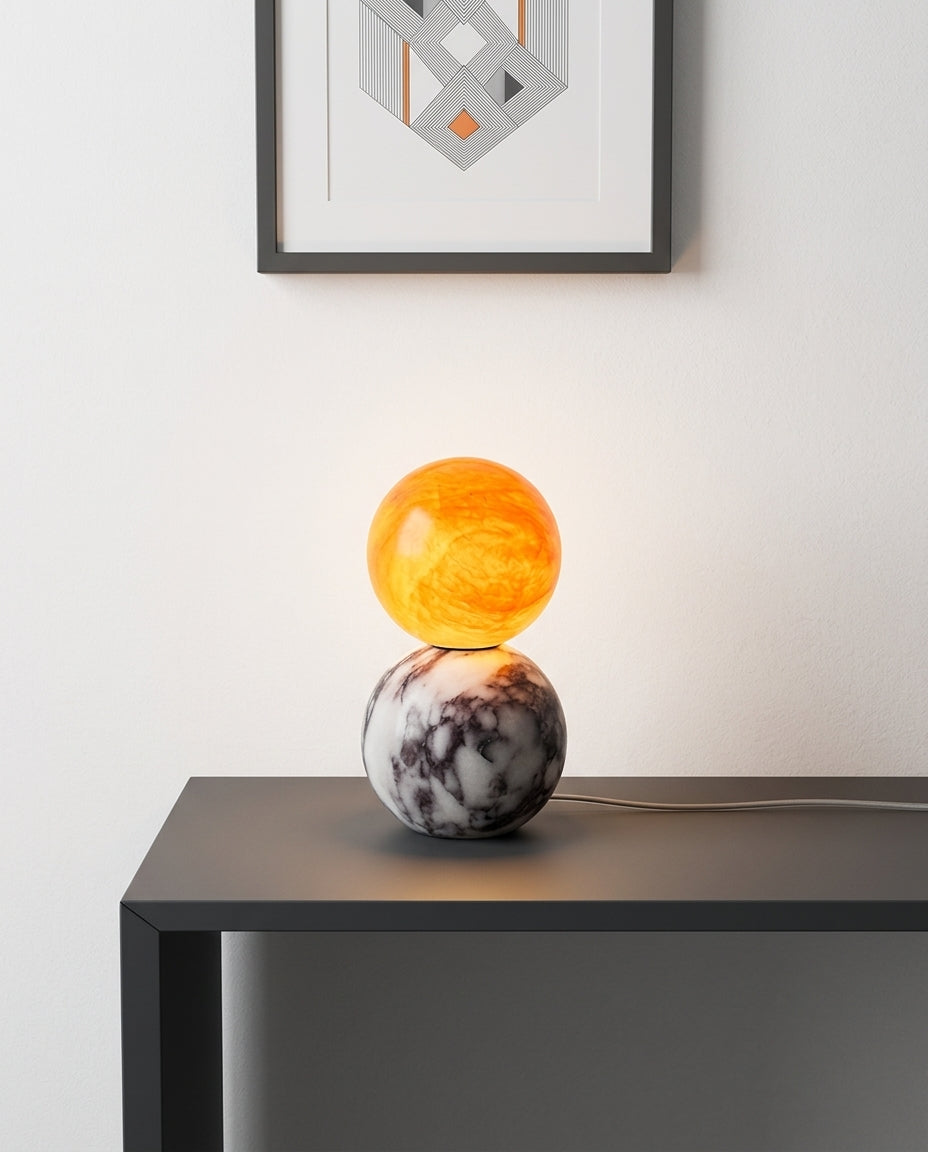 Marble and Alabaster Table Lamp on an entryway console table below a framed print, evening