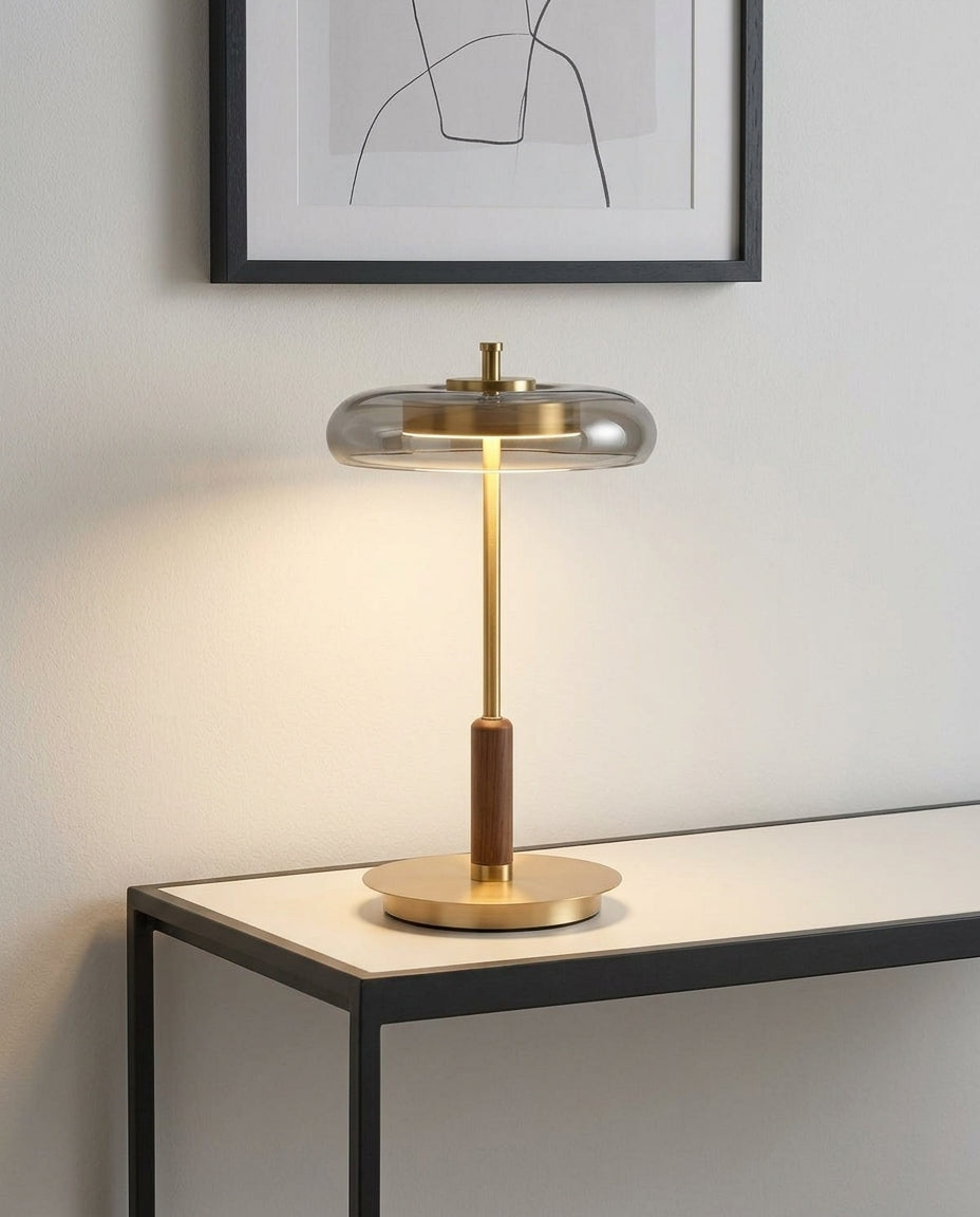 Glass, Walnut and Brass Table Lamp on an entryway console table below a framed print, evening