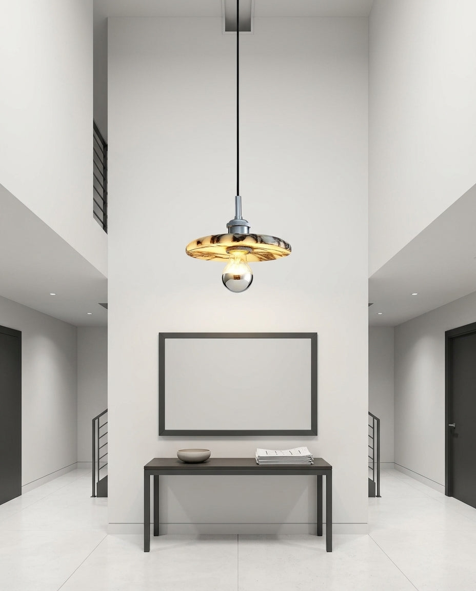 Marble Cylinder Pendant Light hanging in a double-height entryway above a console table, evening