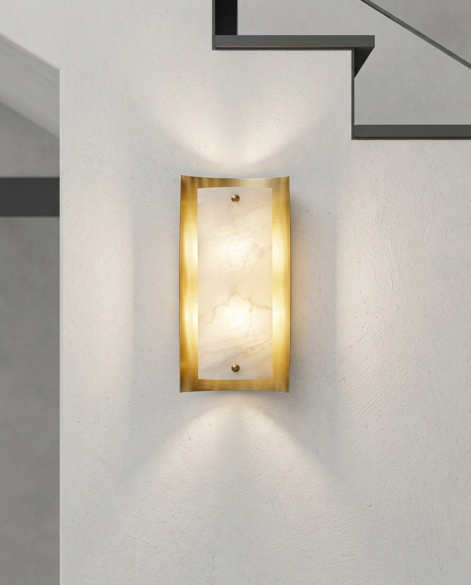 Tall Alabaster and Brass Wall Lamp mounted on the wall of a modern staircase, the light grazing the wall texture