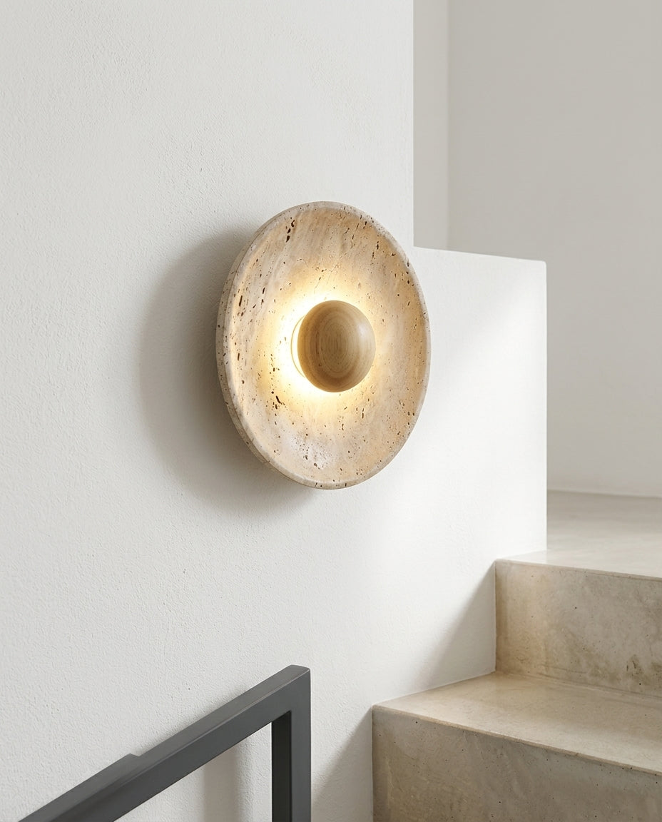 Travertine and Wood Wall Light mounted on the wall of a modern staircase, the light grazing the wall texture