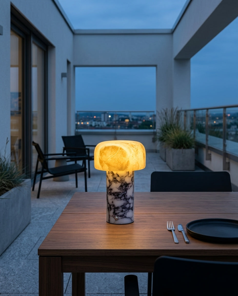 Marble Base Alabaster Shade Lamp on an outdoor dining table on a modern terrace at dusk, no cable anywhere in frame