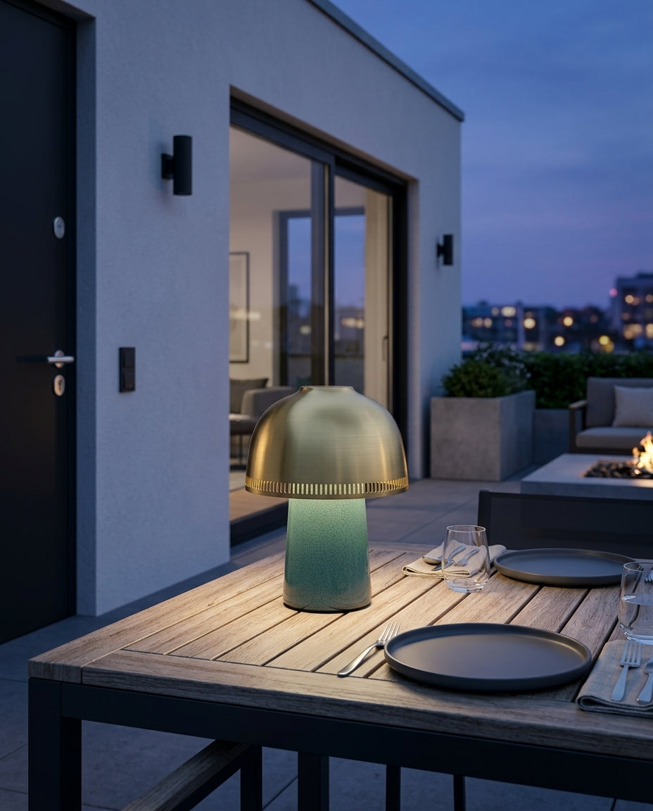Ceramic Cordless Table Lamp on an outdoor dining table on a modern terrace at dusk, no cable anywhere in frame