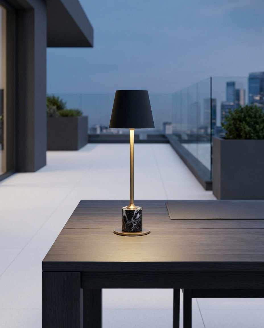 Mini Marble Stem Lamp on an outdoor dining table on a modern terrace at dusk, no cable anywhere in frame