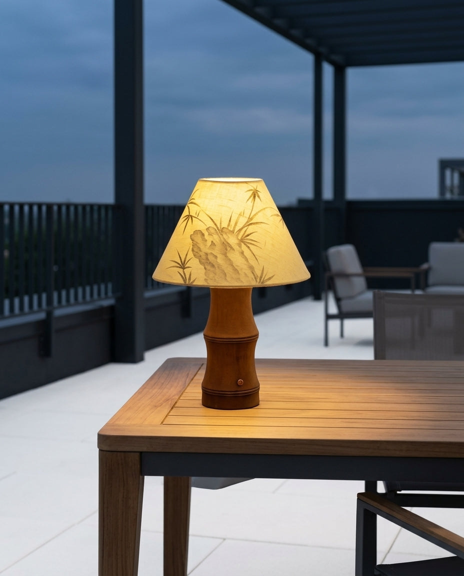 Oak and Linen Cordless Lamp on an outdoor dining table on a modern terrace at dusk, no cable anywhere in frame