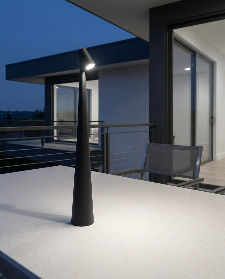 Slim Aluminum Stick Lamp on an outdoor dining table on a modern terrace at dusk, no cable anywhere in frame