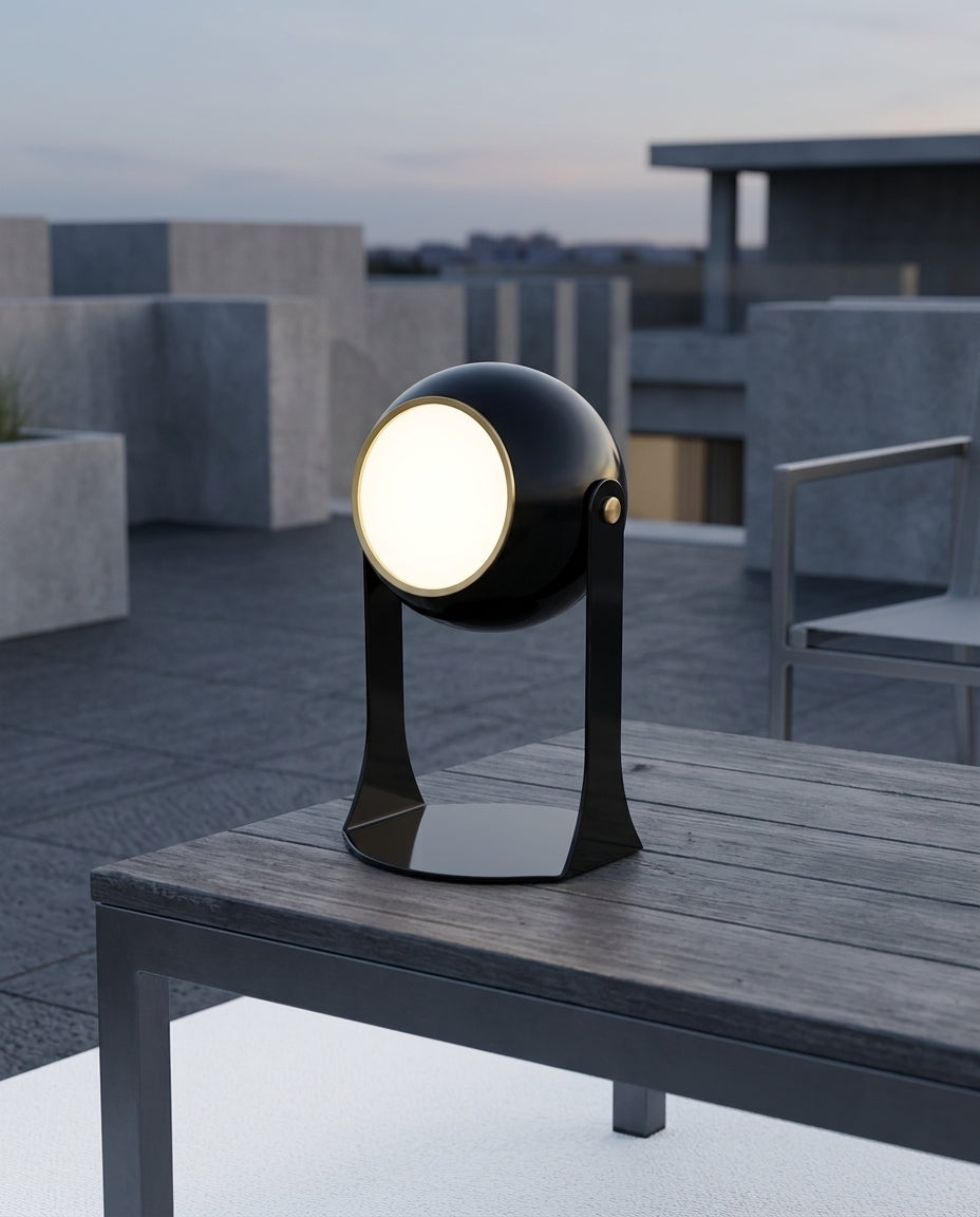 Folding Acrylic Cordless Lamp on an outdoor dining table on a modern terrace at dusk, no cable anywhere in frame